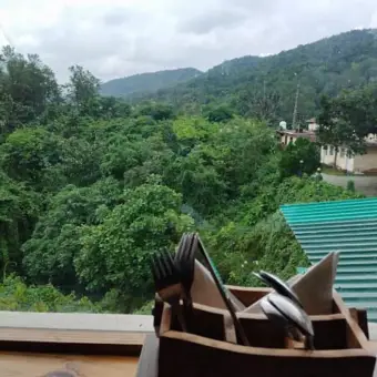 Rooftop bar outdoor seating with mountain views at Aristella Cafe In Rajpur Road Dehradun