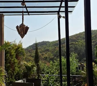 Scenic mountain views from rooftop dining at Aristella Dehradun
